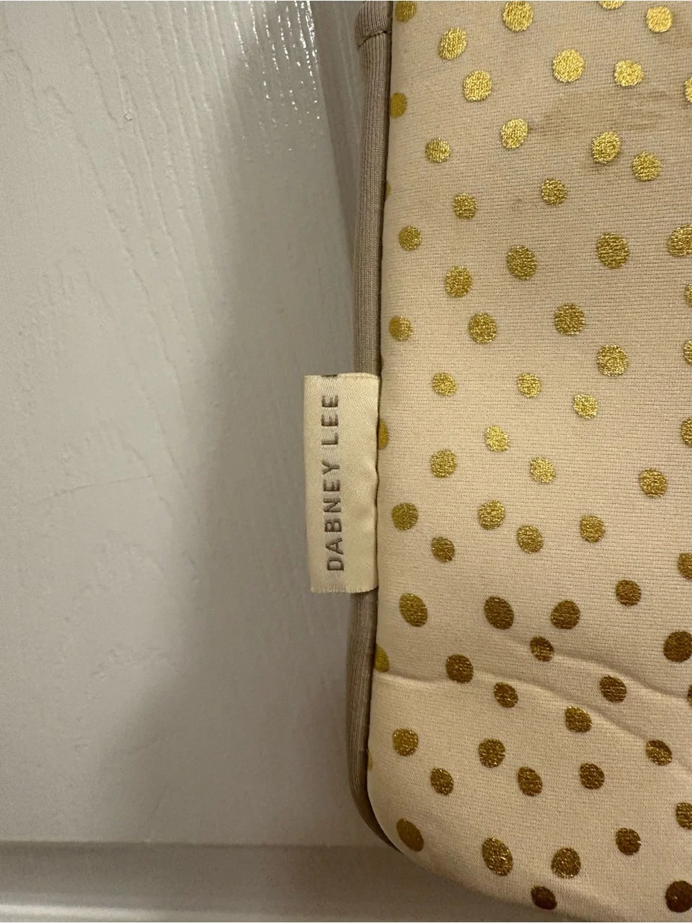 Dabney Lee laptop sleeve in the champagne gold polka dot pattern on cream